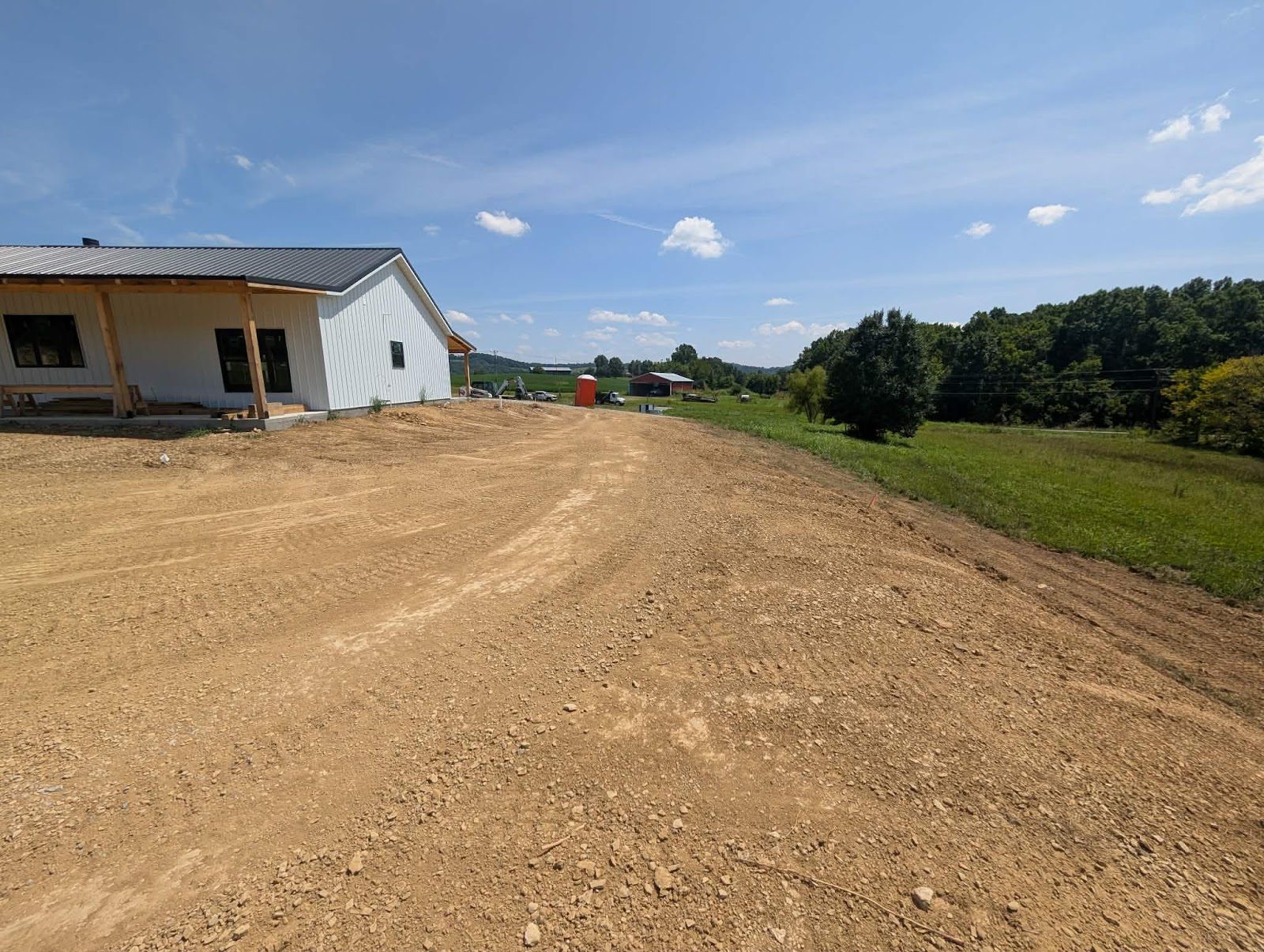 Graded slope beside a house overlooking a field